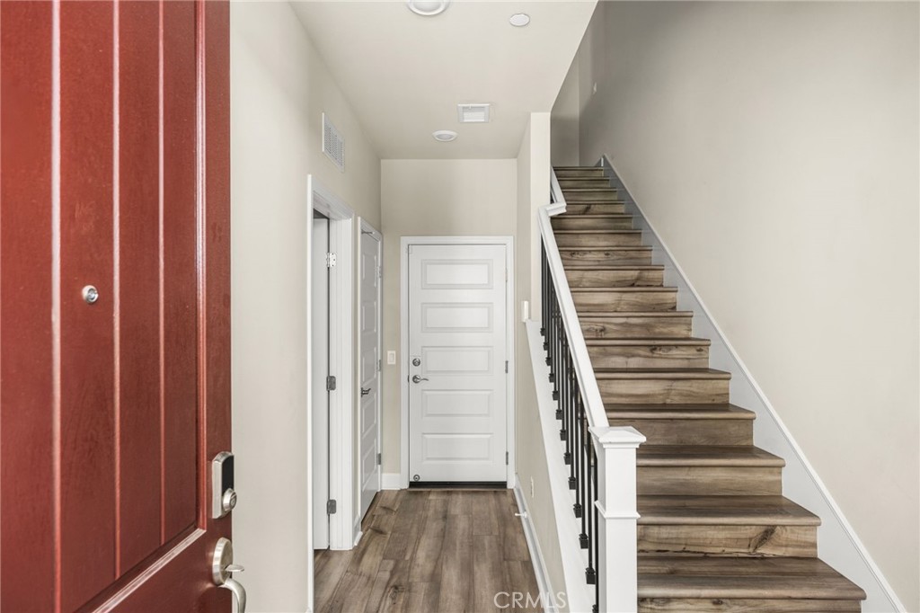 Entry Level, Bedroom with full bath on left, door to Garage straight ahead. - 19114 Azul, Huntington Beach CA 92648 - photo 3