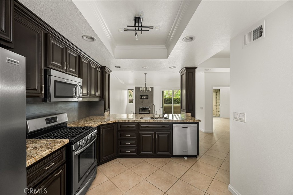 Well-appointed kitchen with generous workspace and storage. - 19442 Sunray 103, Huntington Beach CA 92648 - photo 1