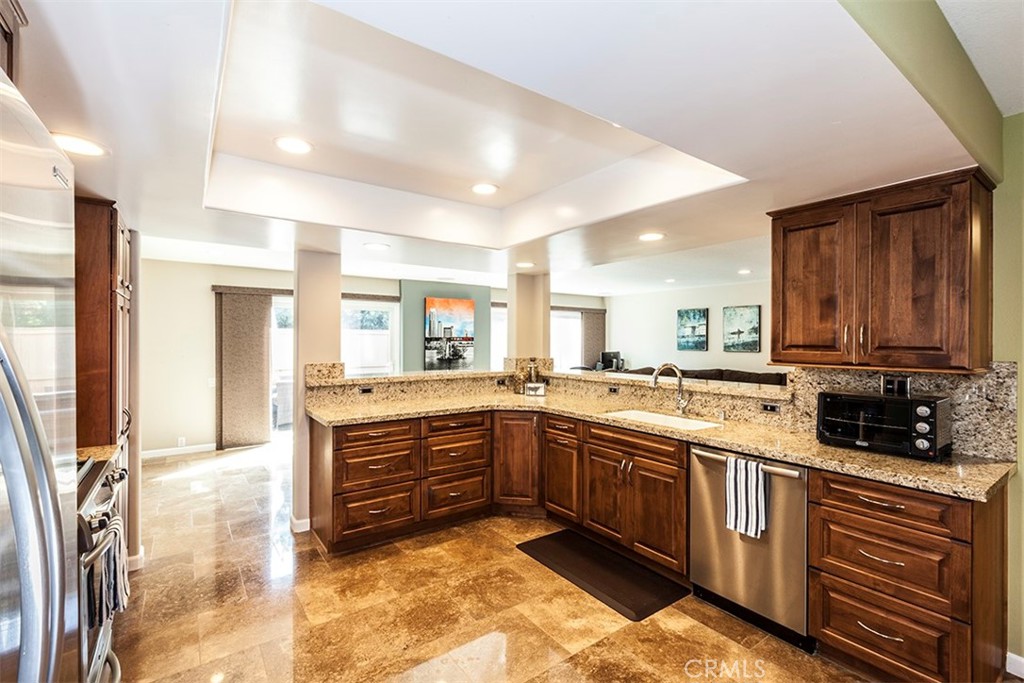 Beautiful and spacious remodeled kitchen w/granite counters, recessed lighting and loads of storage. - 19646 Surfbreaker, Huntington Beach CA 92648 - photo 1