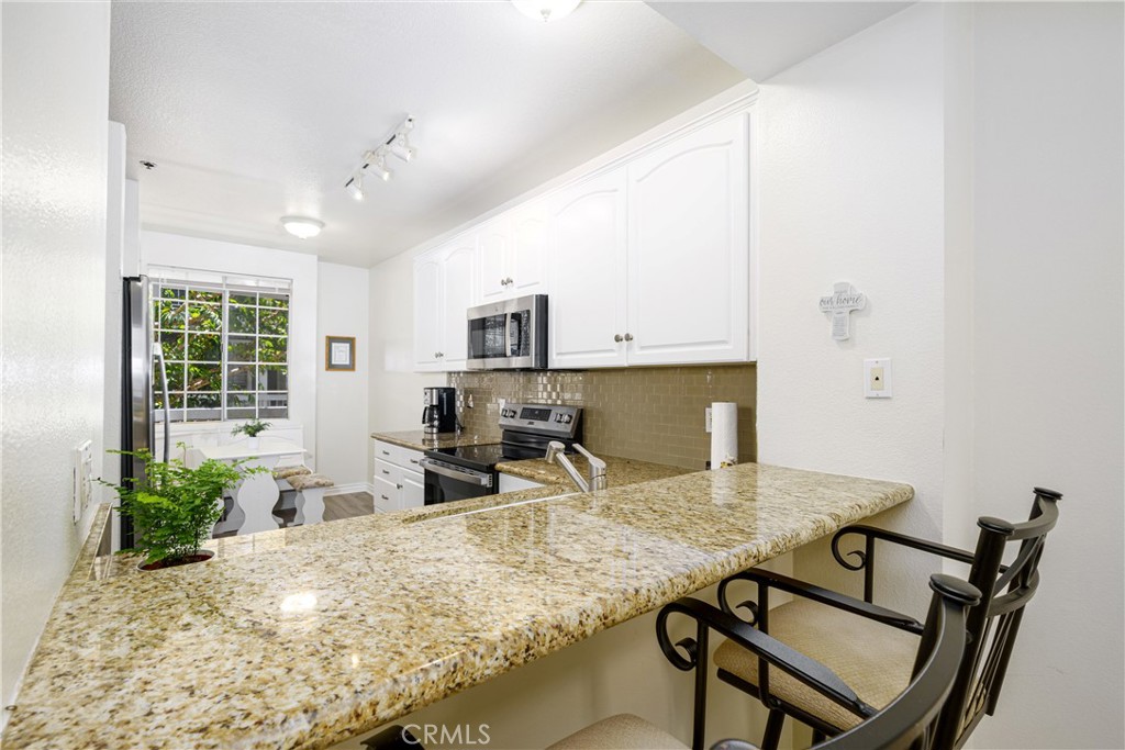 Breakfast Bar, great kitchen with seating area - 20301 Bluffside Circle 211, Huntington Beach CA 92646 - photo 1