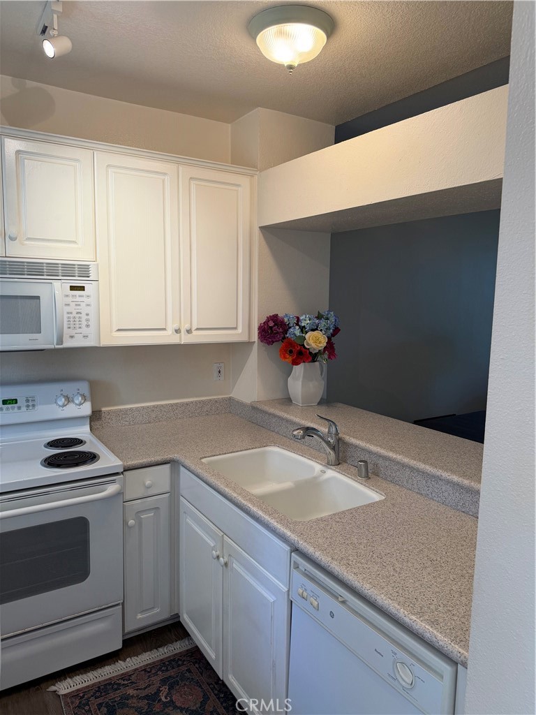 Kitchen view with breakfast bar leading into living room - 20331 Bluffside 309, Huntington Beach CA 92646 - photo 3