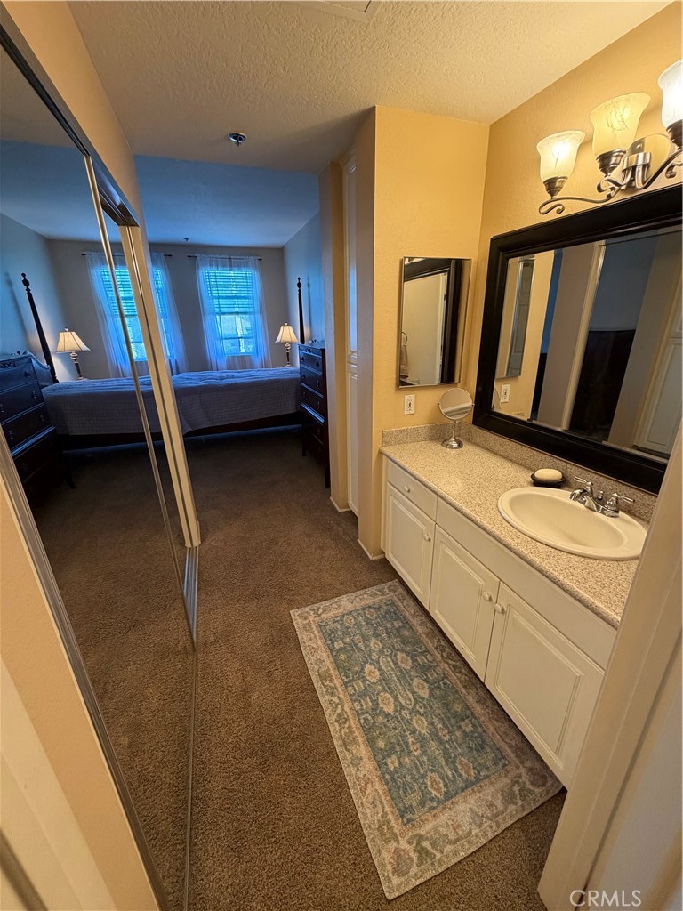 En suite to bathroom from master, second vanity and walk-in closet - 20331 Bluffside 309, Huntington Beach CA 92646 - photo 5
