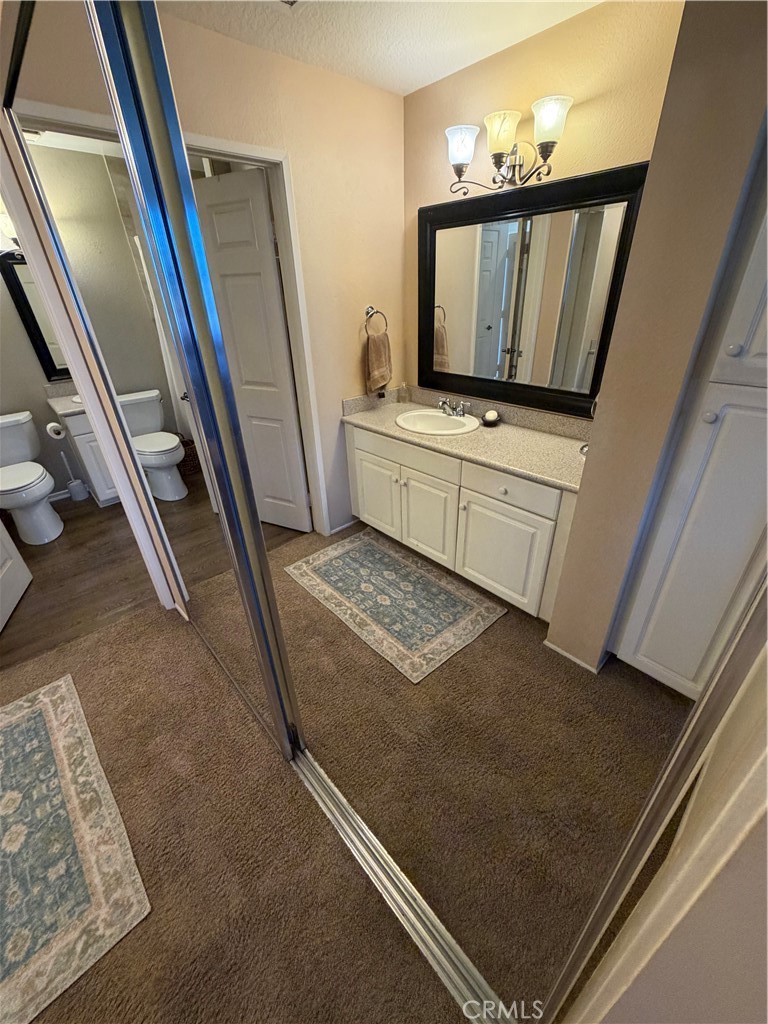 Mirrored closet doors behind second vanity to walk-in closet - 20331 Bluffside 309, Huntington Beach CA 92646 - photo 6