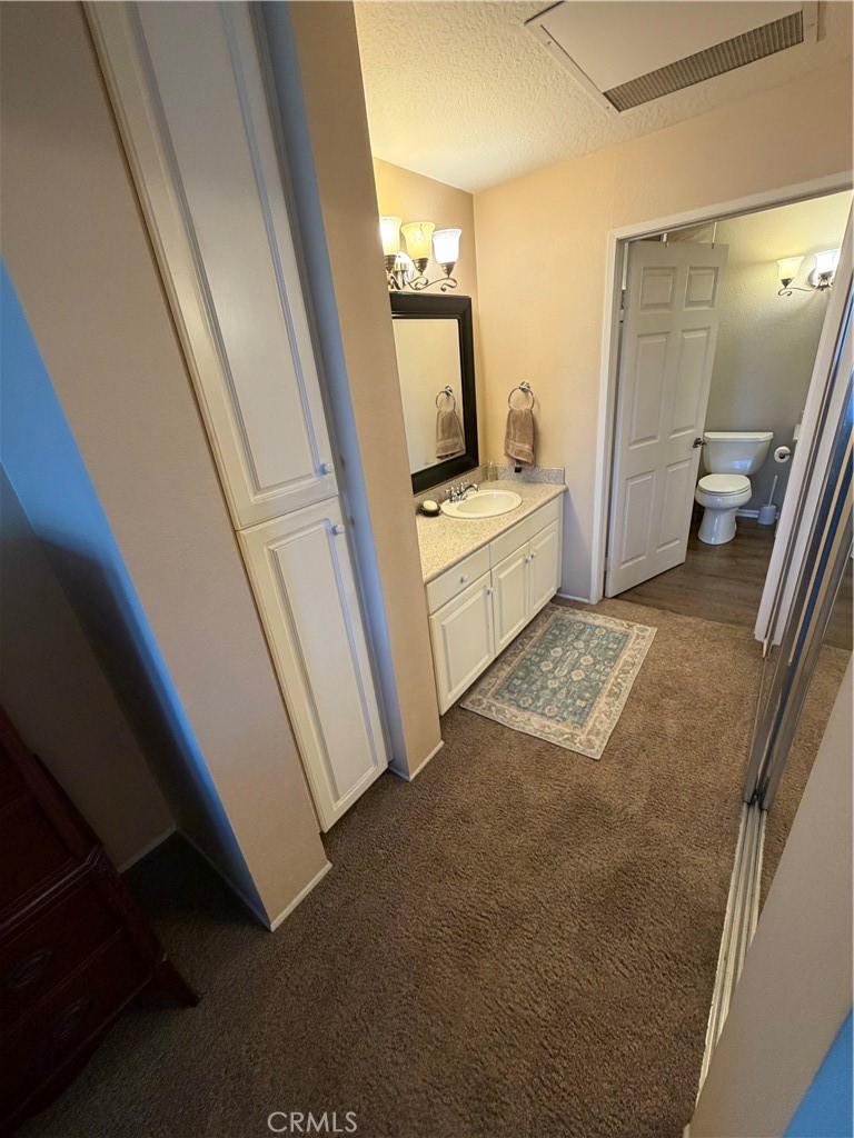 Bedroom view toward bathroom - 20331 Bluffside 309, Huntington Beach CA 92646 - photo 8