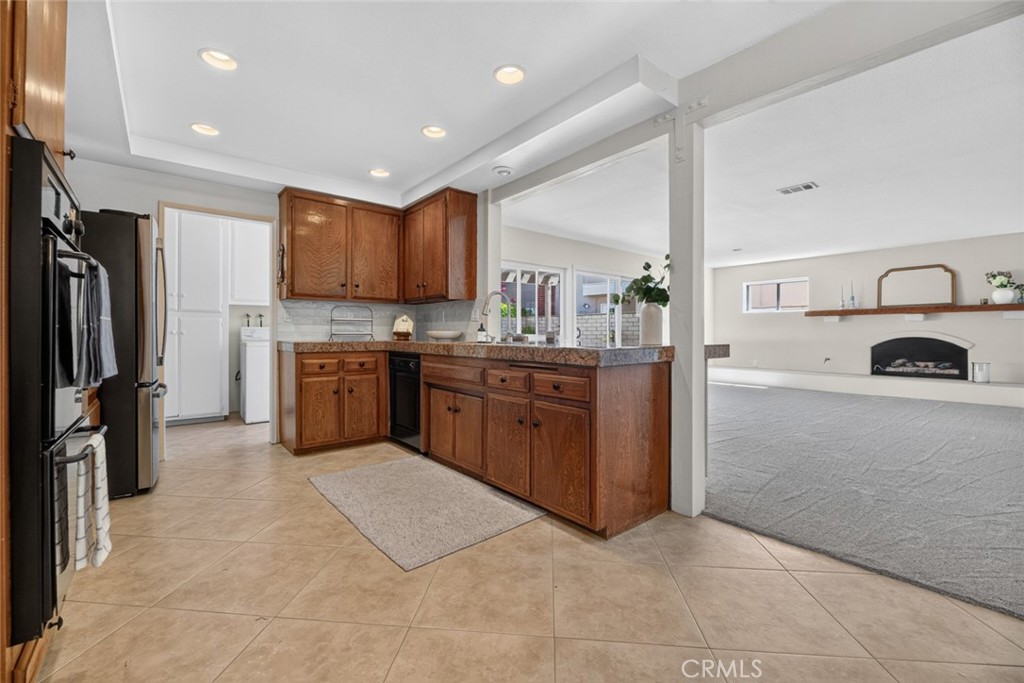 Kitchen flowing to both living spaces - 20682 Hopetown, Huntington Beach CA 92646 - photo 6