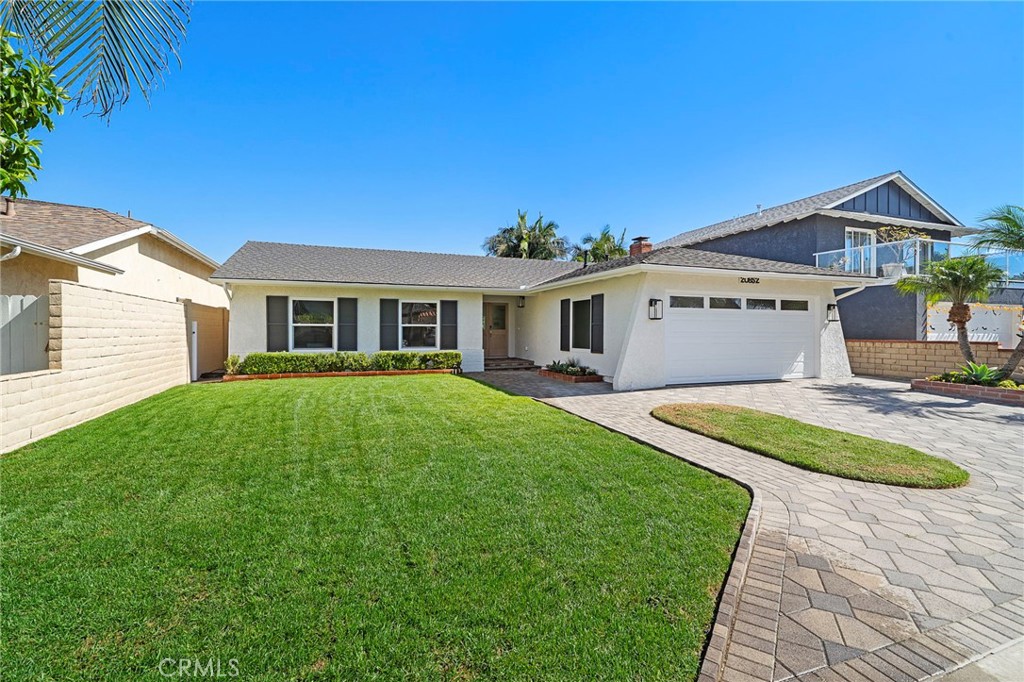 Gorgeous curb appeal with interlocking paver driveway & walkway, lush lawn, raised planters, new paint, and shutters - 20852 Farnsworth Lane, Huntington Beach CA 92646 - photo 2