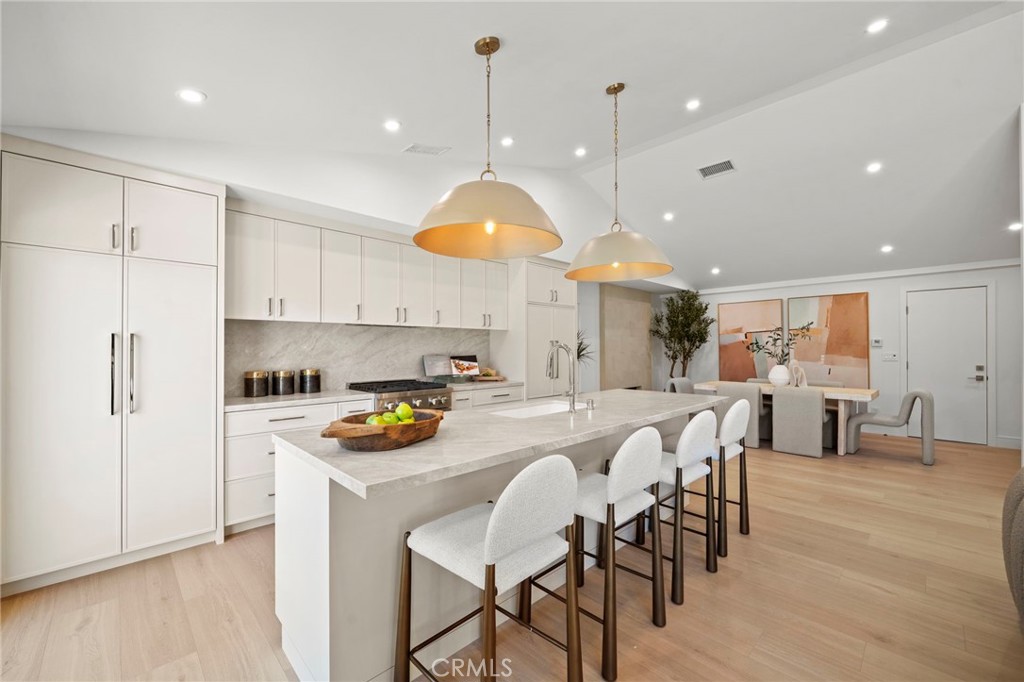 Spectacular chef's kitchen showcases quartz countertops, an entertaining island with bar seating, statement pendant ligh - 20852 Farnsworth Lane, Huntington Beach CA 92646 - photo 7