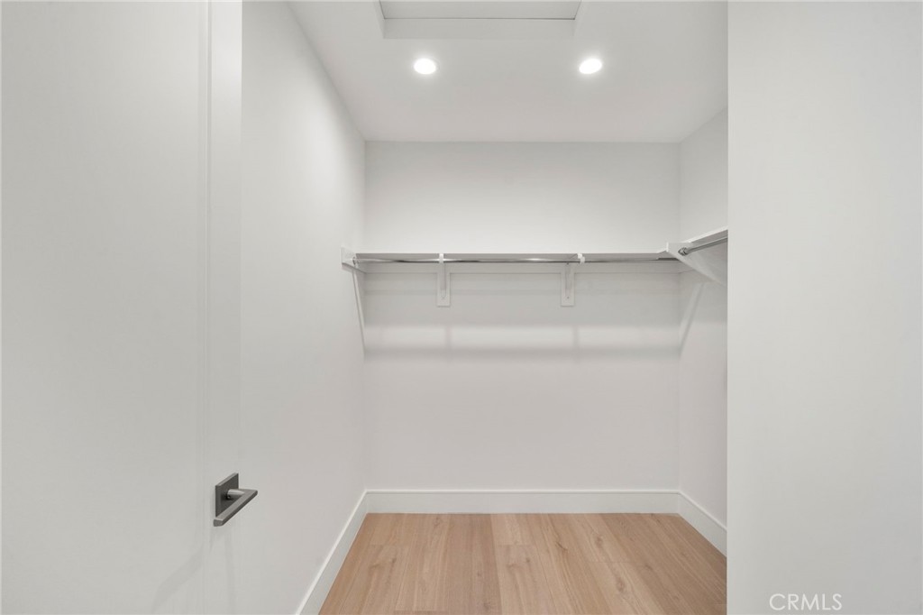 Extra large walk-in closet in primary suite - 20852 Farnsworth Lane, Huntington Beach CA 92646 - photo 20