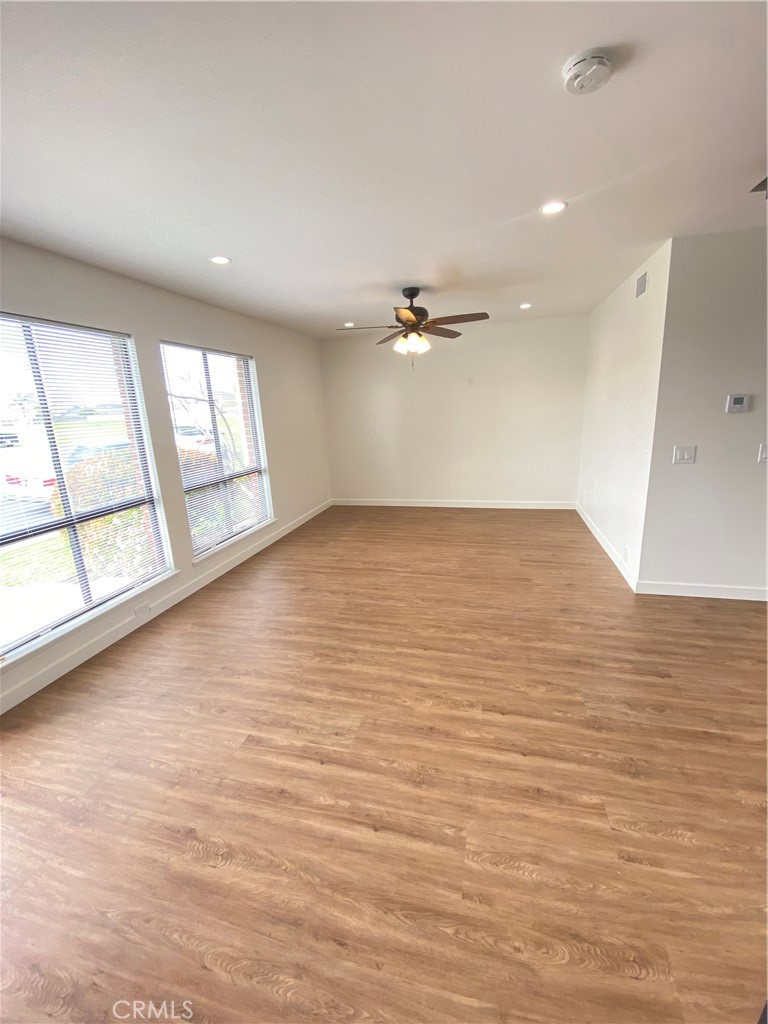 Living rooms with loads of natural light and views of the park. - 21292 GREENSPRAY Lane, Huntington Beach CA 92646 - photo 3