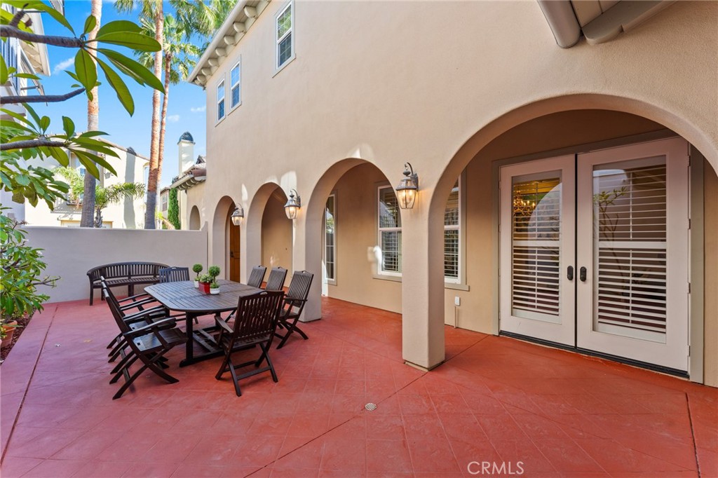 Enter through an expansive private enclosed tropical courtyard with paver decking. - 21306 Balerma, Huntington Beach CA 92648 - photo 4