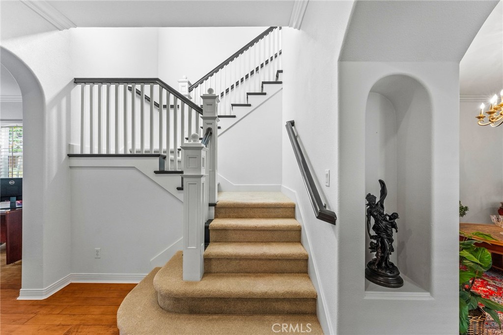Inside, a grand foyer w/decor niches and a dramatic wood staircase sets the stage for the elegance beyond. - 21306 Balerma, Huntington Beach CA 92648 - photo 7