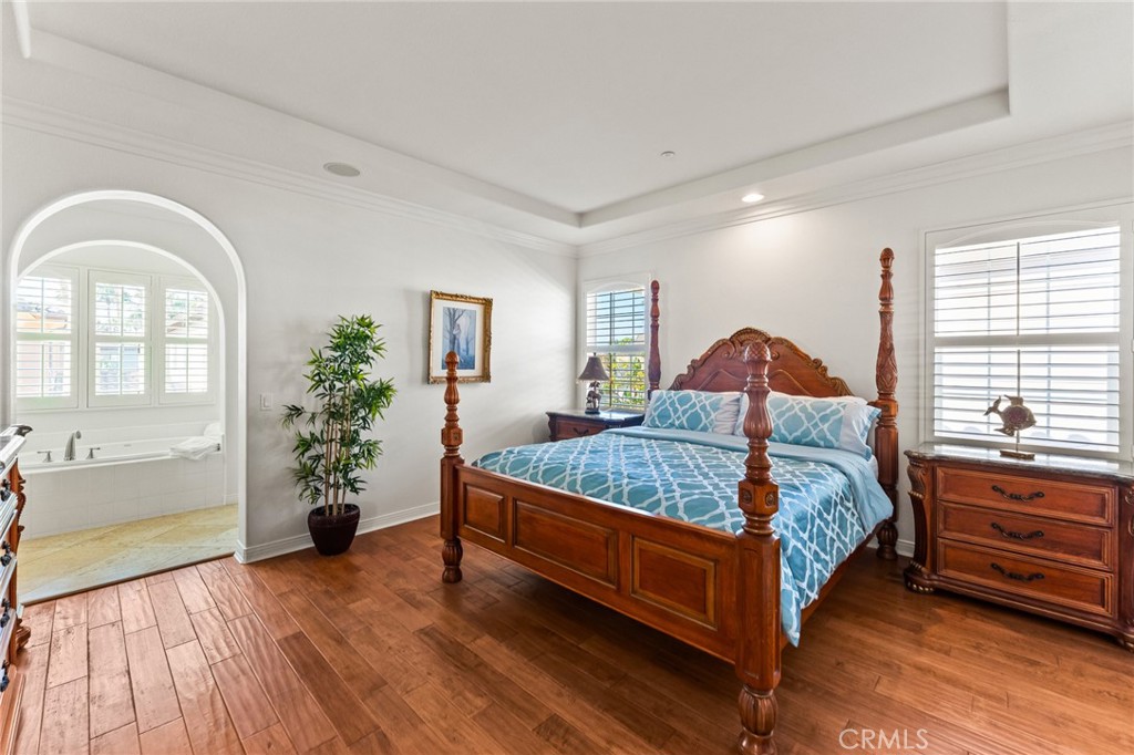 Luxurious primary suite is a private sanctuary with foyer entry, coffered ceiling, separate retreat, enormous walk-in cl - 21306 Balerma, Huntington Beach CA 92648 - photo 30