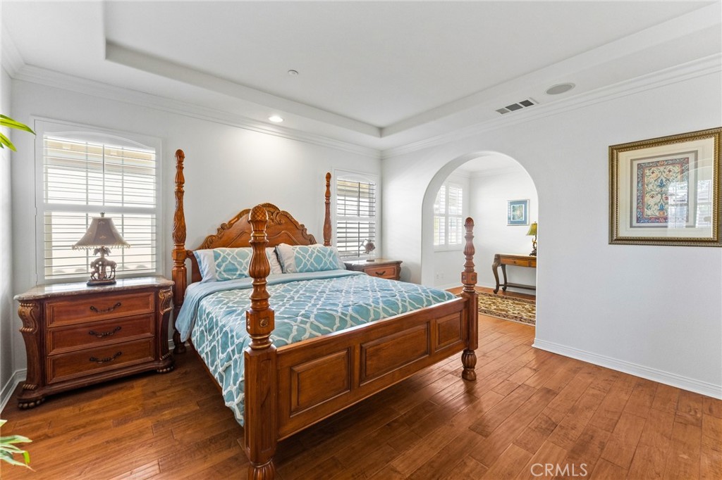 Primary suite with arched passage to private retreat room. - 21306 Balerma, Huntington Beach CA 92648 - photo 32
