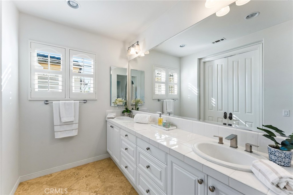 Spa-inspired bath with jetted soaking tub, separate shower, and dual-sink vanity. - 21306 Balerma, Huntington Beach CA 92648 - photo 35