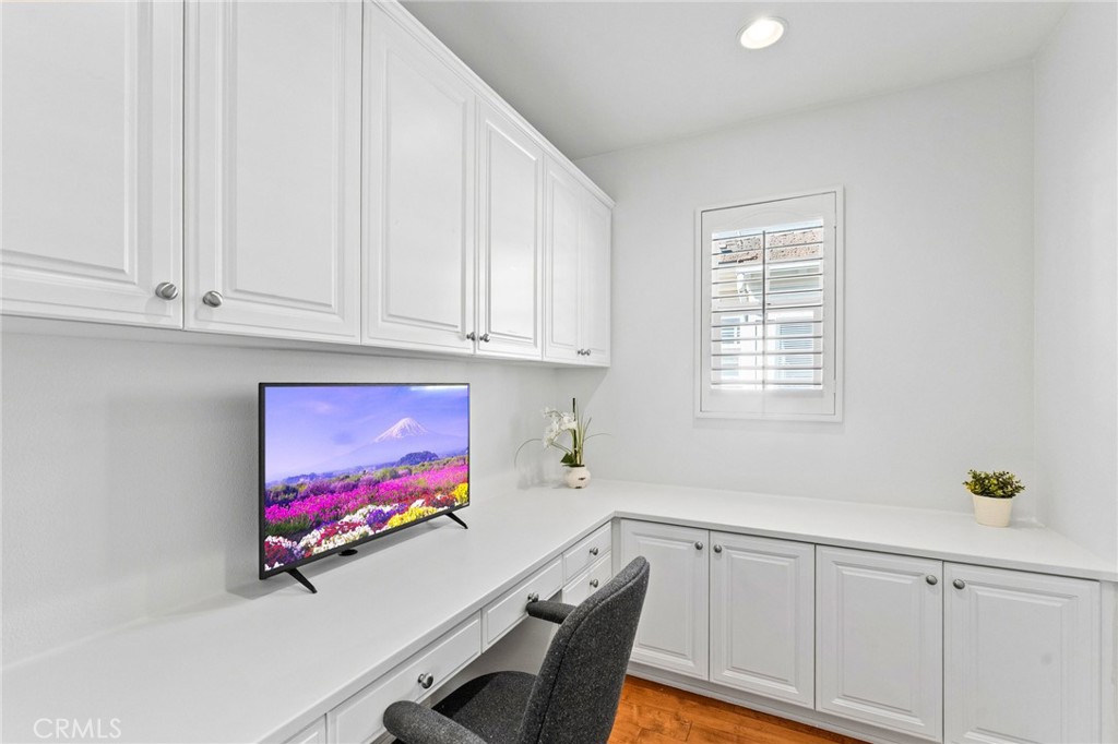 Upstairs loft/office with custom built-in desk and cabinetry. - 21306 Balerma, Huntington Beach CA 92648 - photo 40