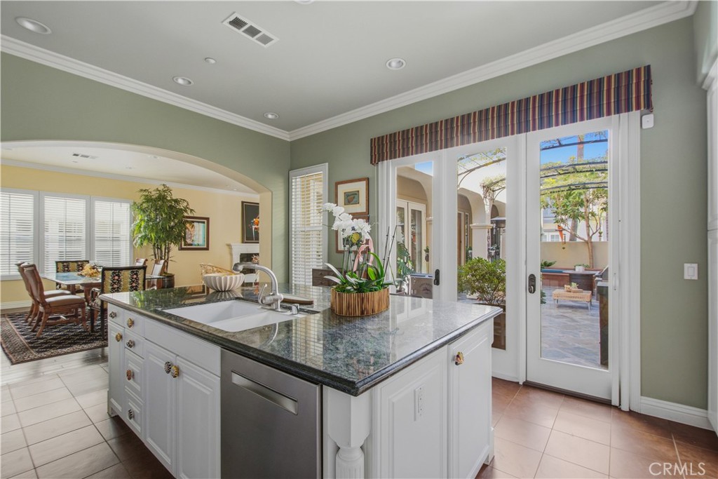 Kitchen center island with white cabinetry, granite counter tops with seating with sink, built in stainless steel dishwa - 21322 Balerma, Huntington Beach CA 92648 - photo 7