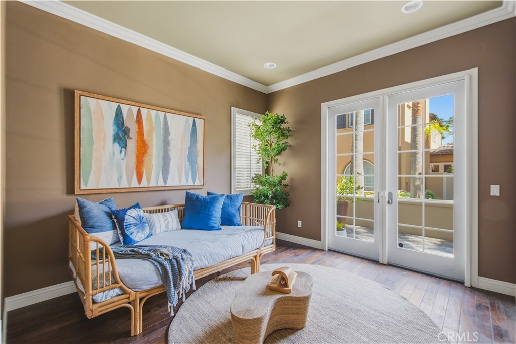 Main floor "bonus" room can be used for a Bedroom/Office/Den with dark wood flooring, tray ceilings with crown molding a - 21322 Balerma, Huntington Beach CA 92648 - photo 16