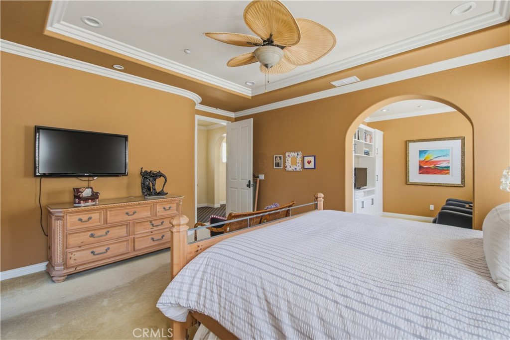 Upper-level Primary bedroom with archway opening into separate sitting area and entry door from hallway. - 21322 Balerma, Huntington Beach CA 92648 - photo 22
