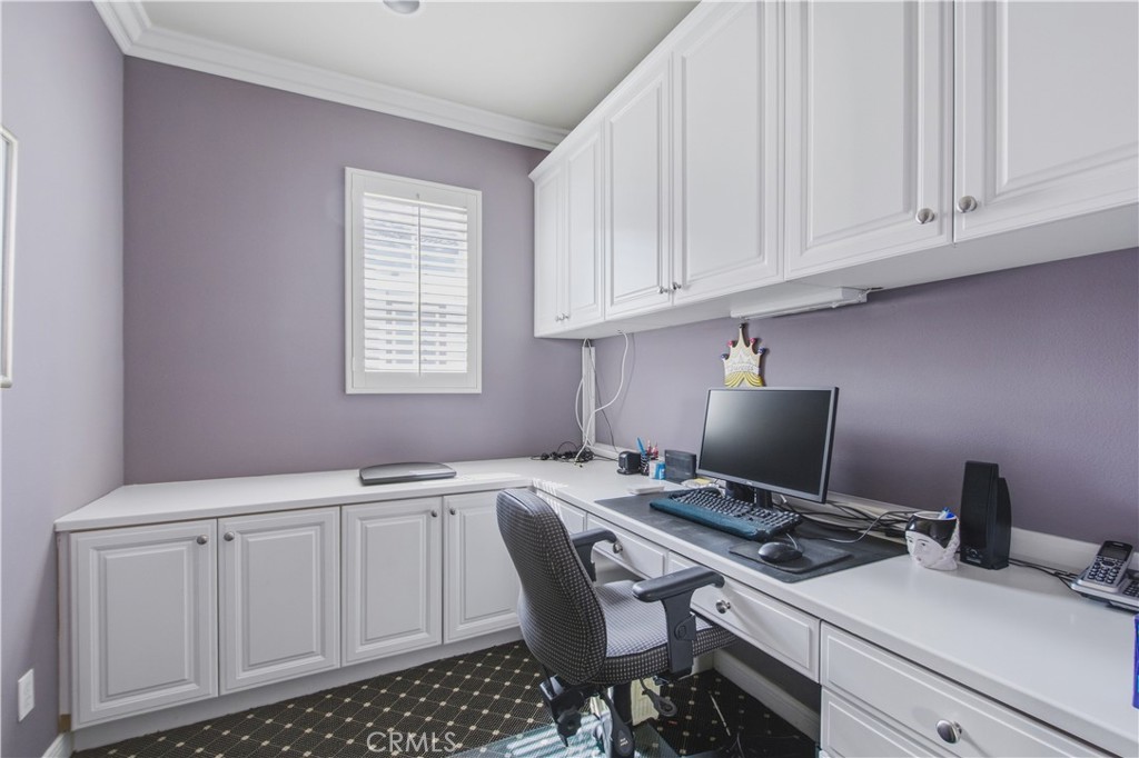 Upper-level office with white built-in cabinetry, upper storage cabinets, lower drawers and cupboards, wrap around work - 21322 Balerma, Huntington Beach CA 92648 - photo 35