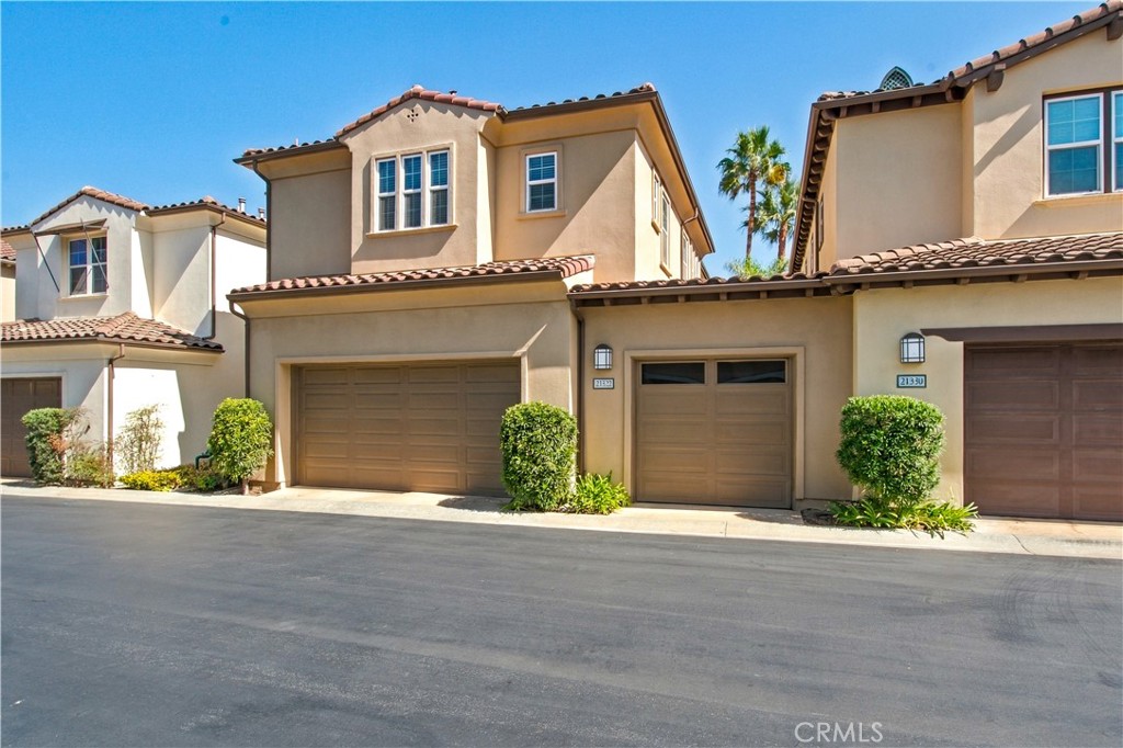 Rear view of home including 3-car garage. - 21322 Balerma, Huntington Beach CA 92648 - photo 56