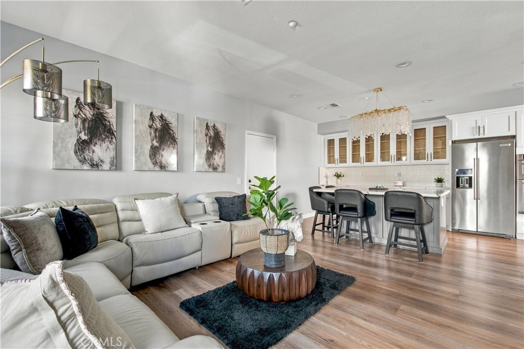 The inviting living room opens to a showstopping chef-inspired kitchen and gathering space anchored by an expansive quar - 21335 Cieza, Huntington Beach CA 92648 - photo 14