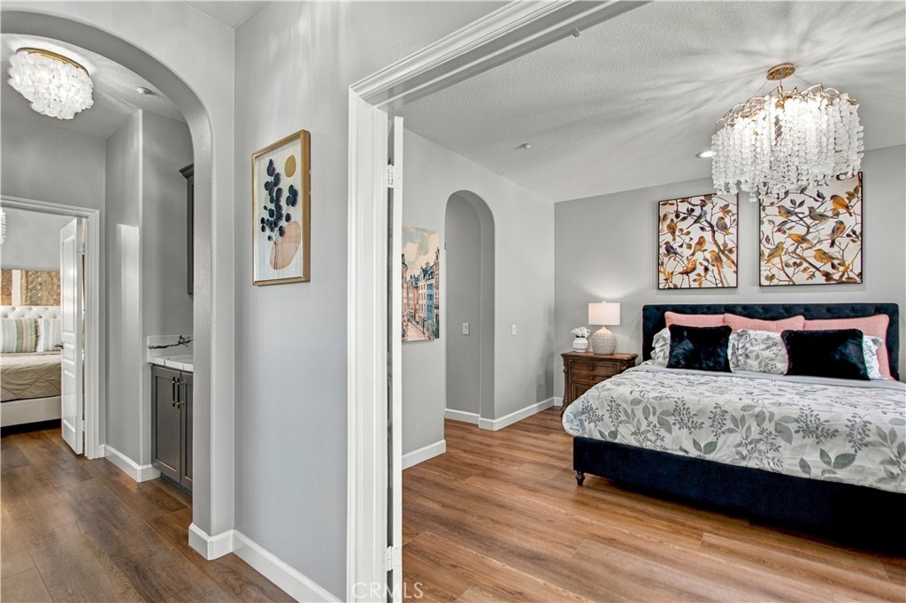 The luxurious primary suite features French doors opening to a charming Juliet balcony, dual custom-organized walk-in cl - 21335 Cieza, Huntington Beach CA 92648 - photo 30