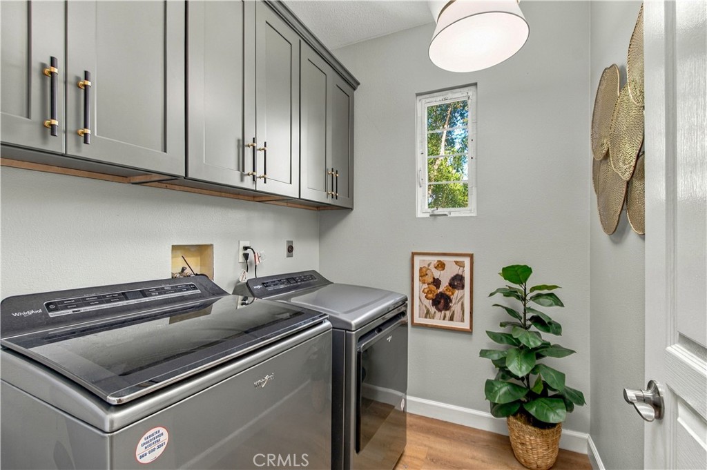 Convenient upstairs laundry with cabinetry. - 21335 Cieza, Huntington Beach CA 92648 - photo 44