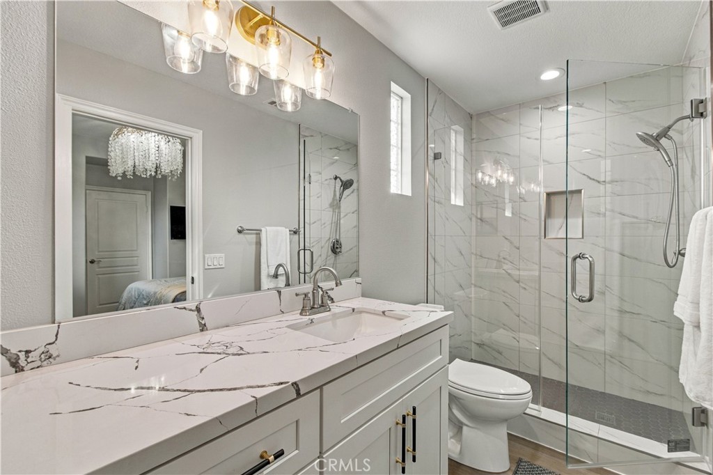 The secondary suite offers its own beautifully appointed bath with walk-in shower. - 21335 Cieza, Huntington Beach CA 92648 - photo 47