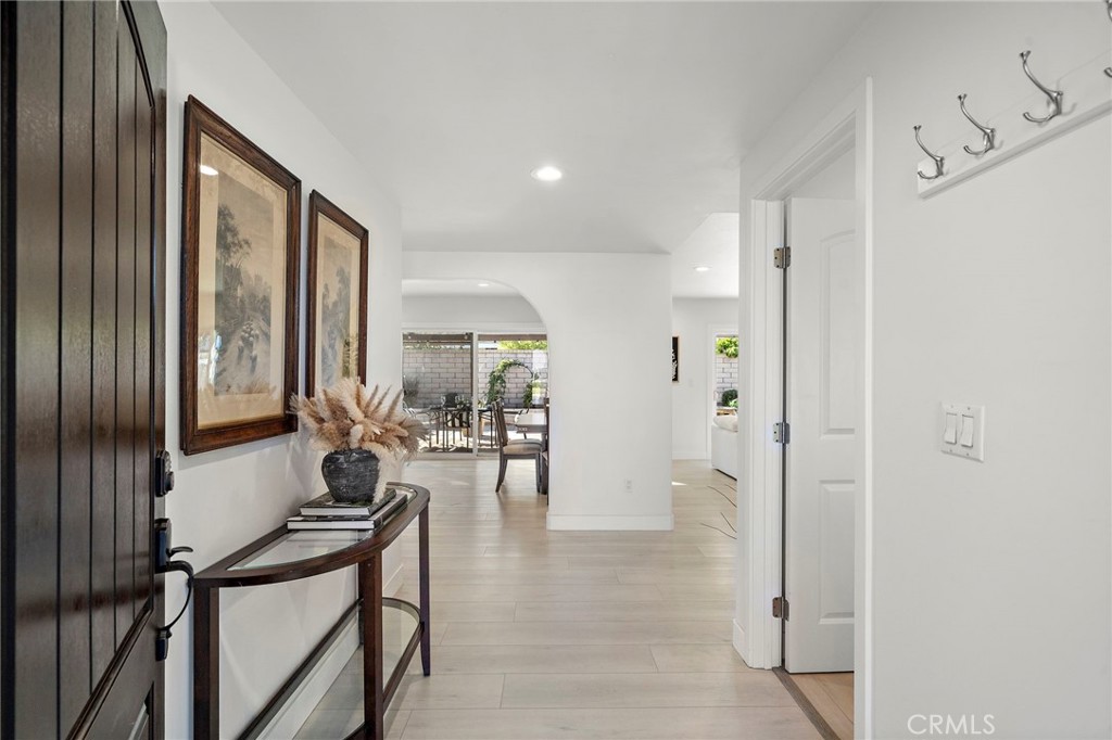 Welcomes you through a custom entry door with sidelights into a formal foyer - 21341 Seaforth Lane, Huntington Beach CA 92646 - photo 3
