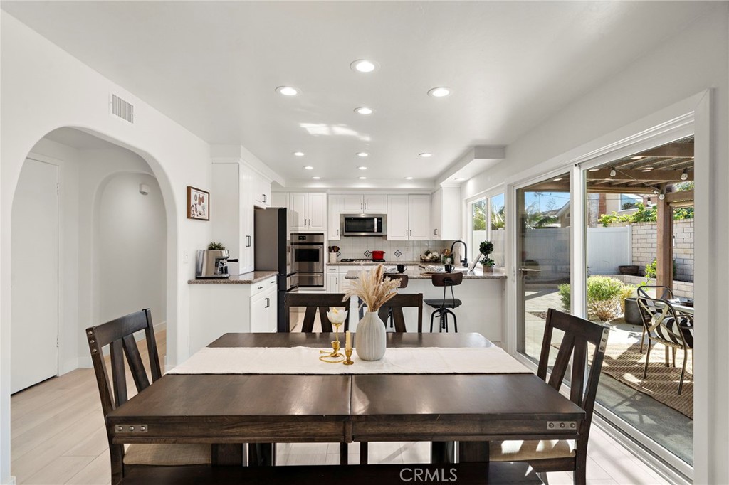 Dramatic arched passageways, raised-panel doors, and custom dark-wood - 21341 Seaforth Lane, Huntington Beach CA 92646 - photo 8