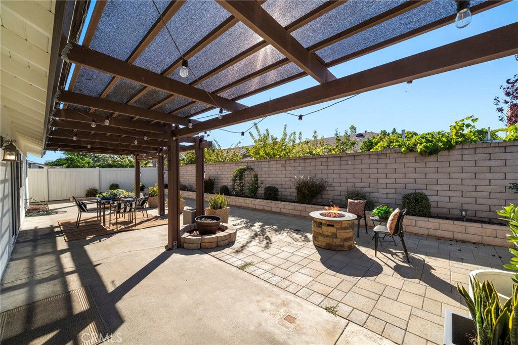Outside, a tranquil backyard retreat awaits with a covered patio - 21341 Seaforth Lane, Huntington Beach CA 92646 - photo 30
