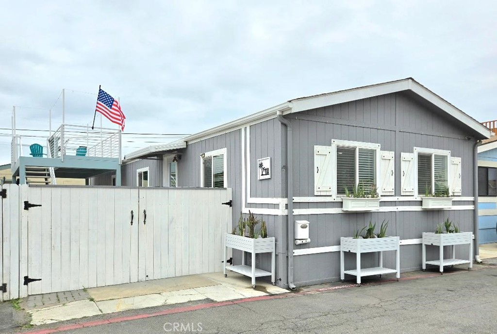 Front of home, double side Gate, & private deck - 21752 Pacific coast hwy 11A, Huntington Beach CA 92646 - photo 1