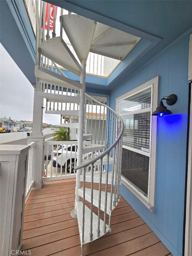Front Patio with spiral staircase - 21851 Newland St 66, Huntington Beach CA 92646 - photo 16