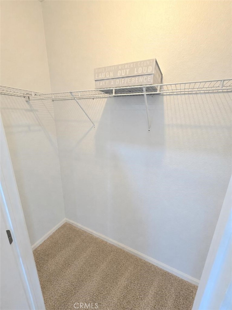 Mater bedroom walk-in closet - 21851 Newland St 66, Huntington Beach CA 92646 - photo 36
