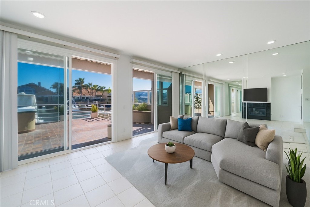 Virtually Staged- Open living space with fireplace, open to dining room and kitchen. Built in wet bar. With two sliders - 3310 Tempe Drive, Huntington Beach CA 92649 - photo 1
