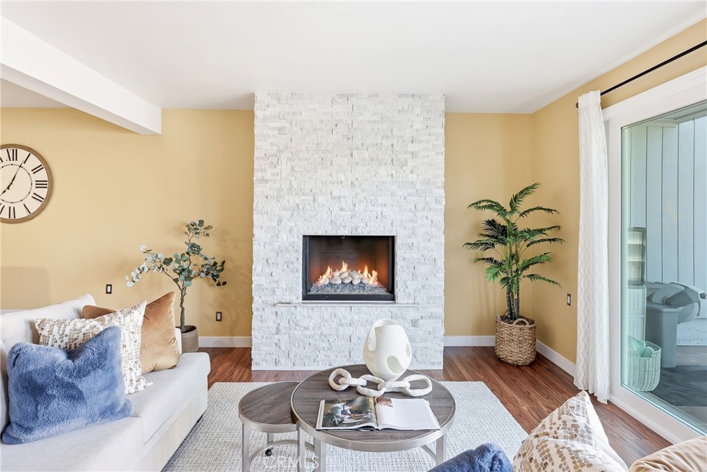 Spacious family room features a custom-designed gas fireplace and opens directly to your huge patio. - 3631 Windspun Drive Drive, Huntington Beach CA 92649 - photo 11