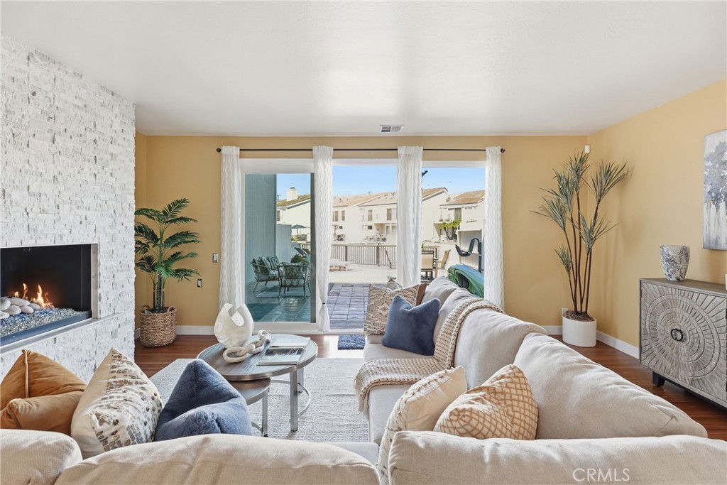 The dining room and family room both showcase breathtaking waterfront views, creating a beautiful and serene setting for - 3631 Windspun Drive Drive, Huntington Beach CA 92649 - photo 12