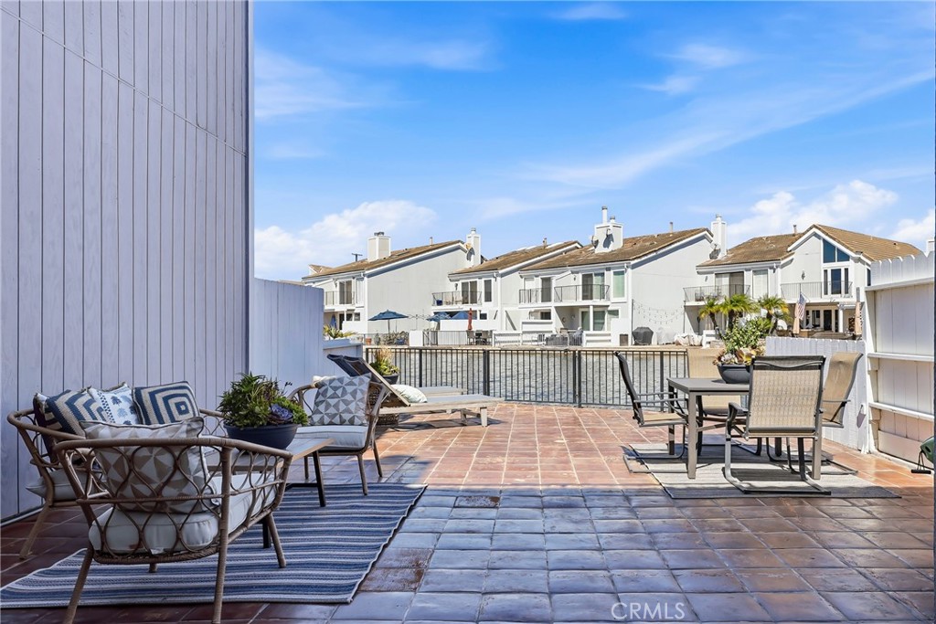 This expansive 800-square-foot waterfront patio offers an exceptional setting for entertaining, relaxing, and enjoying b - 3631 Windspun Drive Drive, Huntington Beach CA 92649 - photo 19