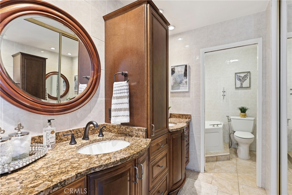 Primary bath with dual vanities, granite counters, and lots of storage. There's another large closet to the right. - 3631 Windspun Drive Drive, Huntington Beach CA 92649 - photo 28