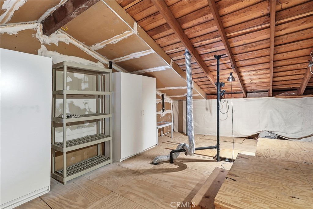 The attic is easy access with wood flooring and holds plenty of storage. - 3631 Windspun Drive Drive, Huntington Beach CA 92649 - photo 33