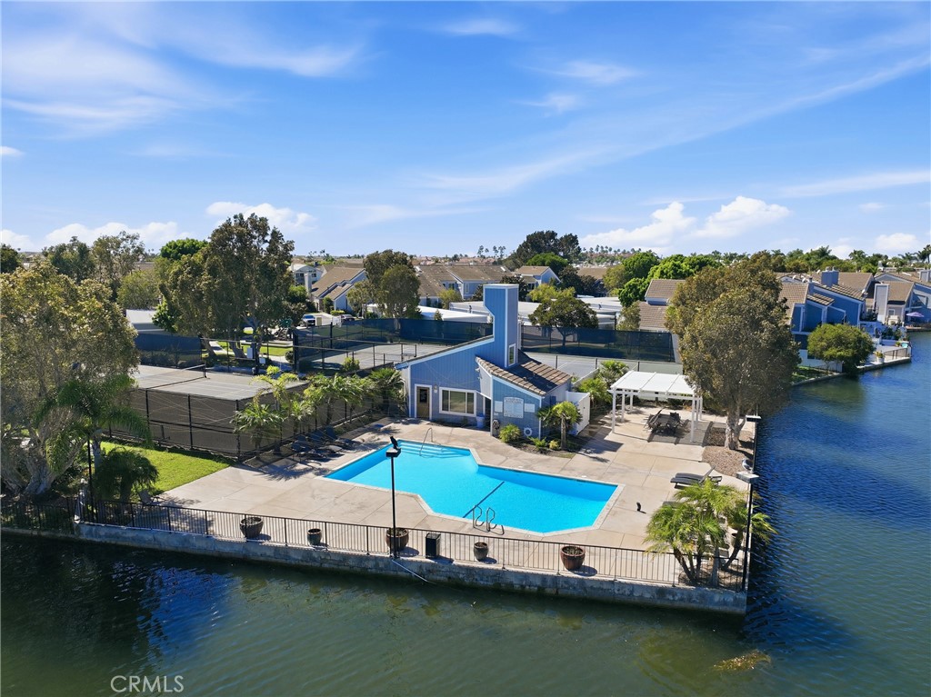 Enjoy resort-style amenities featuring a large pool, clubhouse, and sports courts conveniently located near each other. - 3631 Windspun Drive Drive, Huntington Beach CA 92649 - photo 41