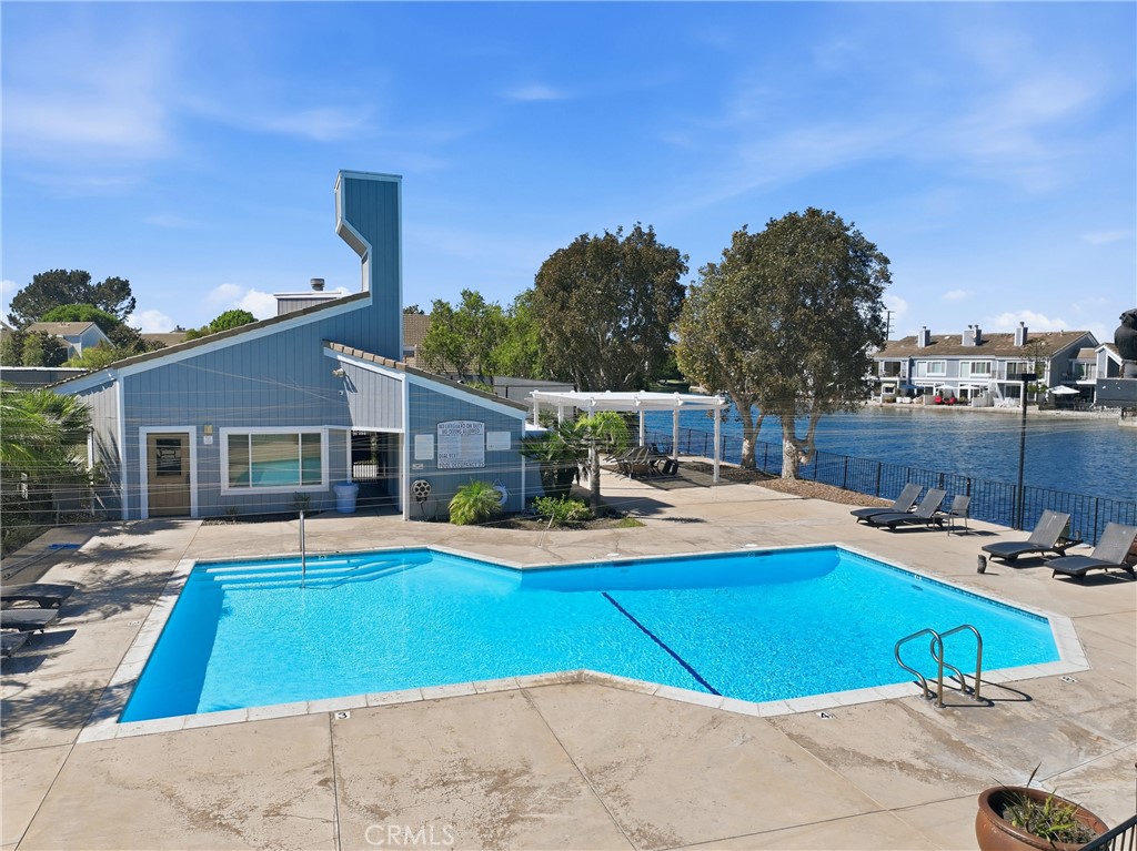 Spacious community pool with plenty of lounging areas to relax, unwind, and soak up the sunshine. - 3631 Windspun Drive Drive, Huntington Beach CA 92649 - photo 42