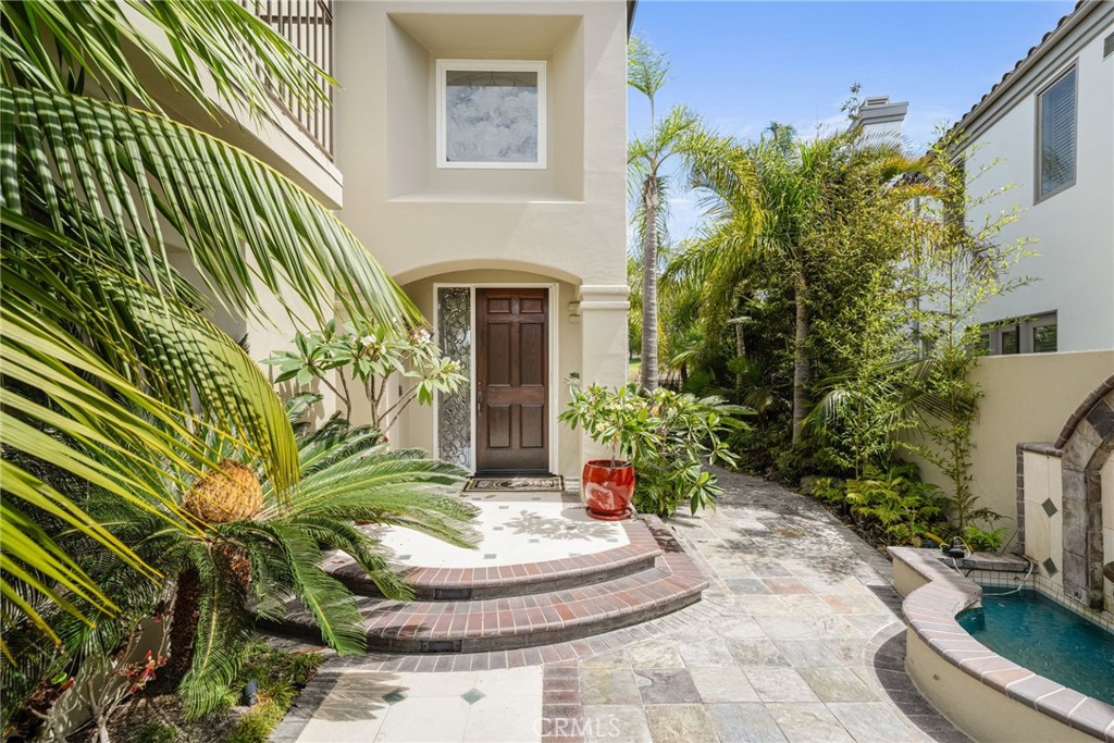 A private courtyard with a beautiful fountain welcomes your guests. - 6461 Morningside Drive, Huntington Beach CA 92648 - photo 5