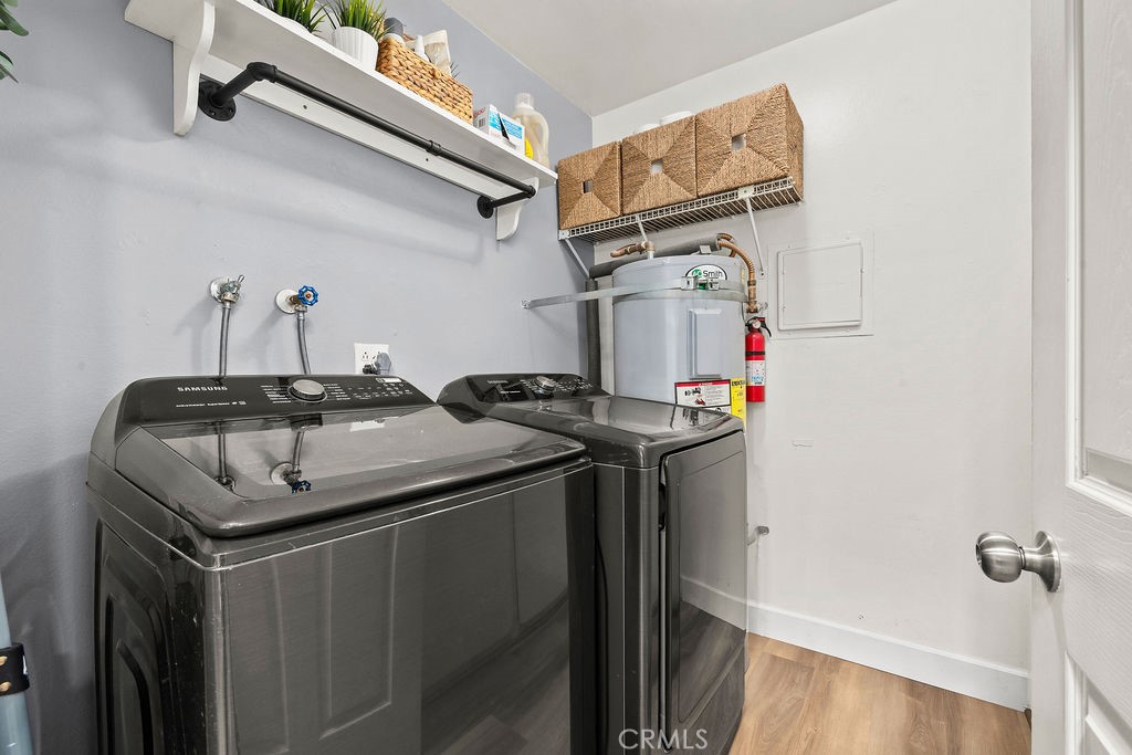 Laundry room with additional storage and shelves behind the door - 6711 Sun C, Huntington Beach CA 92647 - photo 30