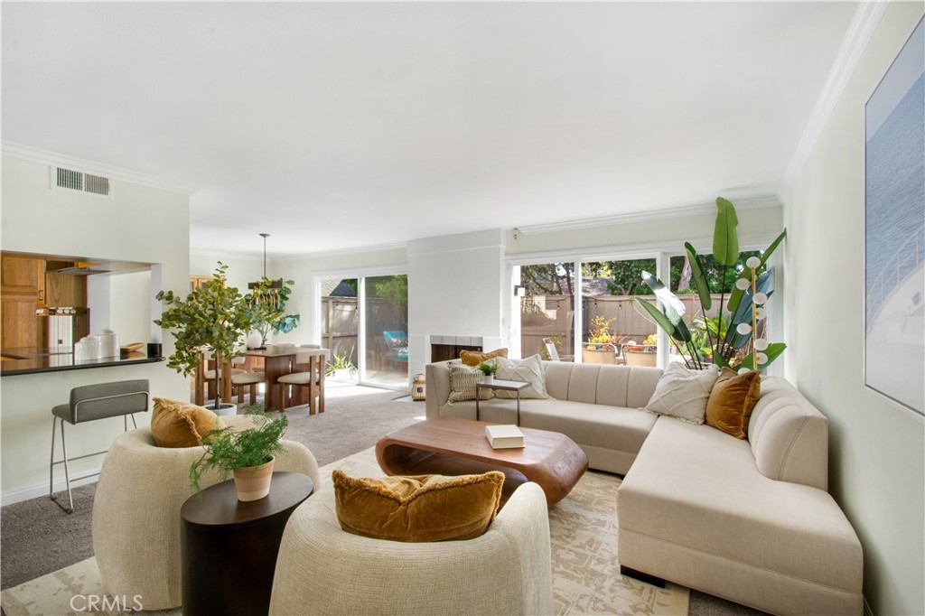 Family room including carpet, breakfast bar, and fireplace leading into dining room area and 2 dual pane sliders. 1 in t - 7246 Seashark, Huntington Beach CA 92648 - photo 1