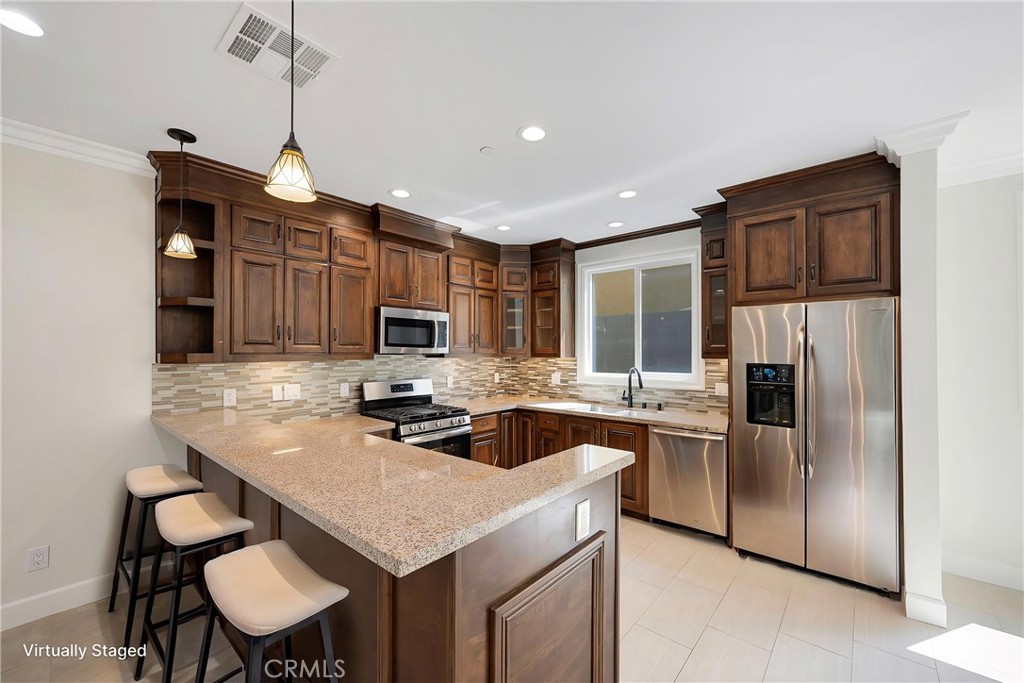 Beautiful Kitchen With Stainless Steel Appliances. Virtually Staged with Stools and Refrigerator. - 7776 Liberty, Huntington Beach CA 92647 - photo 3