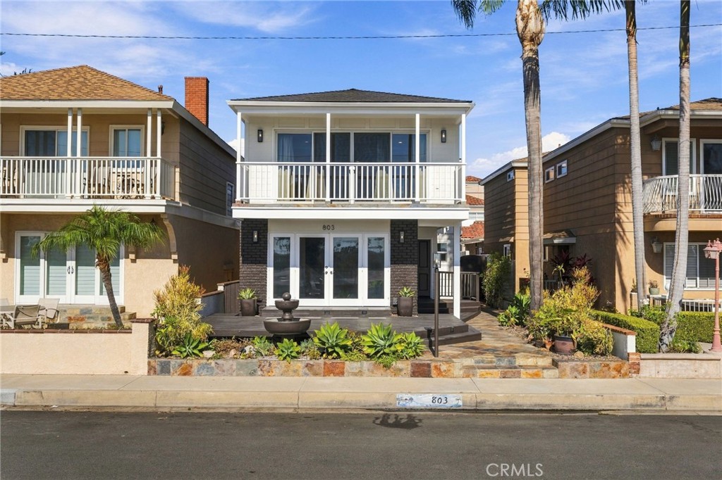 A closer look at the home's refreshed exterior, mature landscaping, and expansive front deck. - 803 Frankfort Avenue, Huntington Beach CA 92648 - photo 2