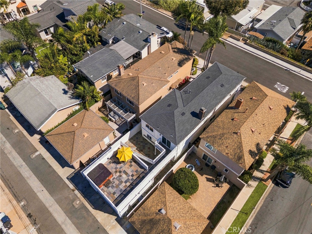 Aerial view showcases the property, detached garage, and multiple outdoor living areas. - 803 Frankfort Avenue, Huntington Beach CA 92648 - photo 4
