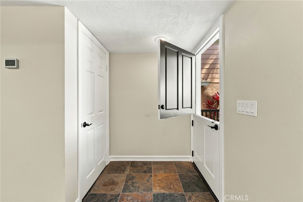 Welcoming entry with Dutch door opens to bright interiors with tile flooring and recessed lighting. - 803 Frankfort Avenue, Huntington Beach CA 92648 - photo 9