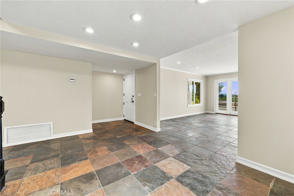 Spacious living room features crown molding, recessed lighting, dual-pane windows, and direct access to the front deck. - 803 Frankfort Avenue, Huntington Beach CA 92648 - photo 10